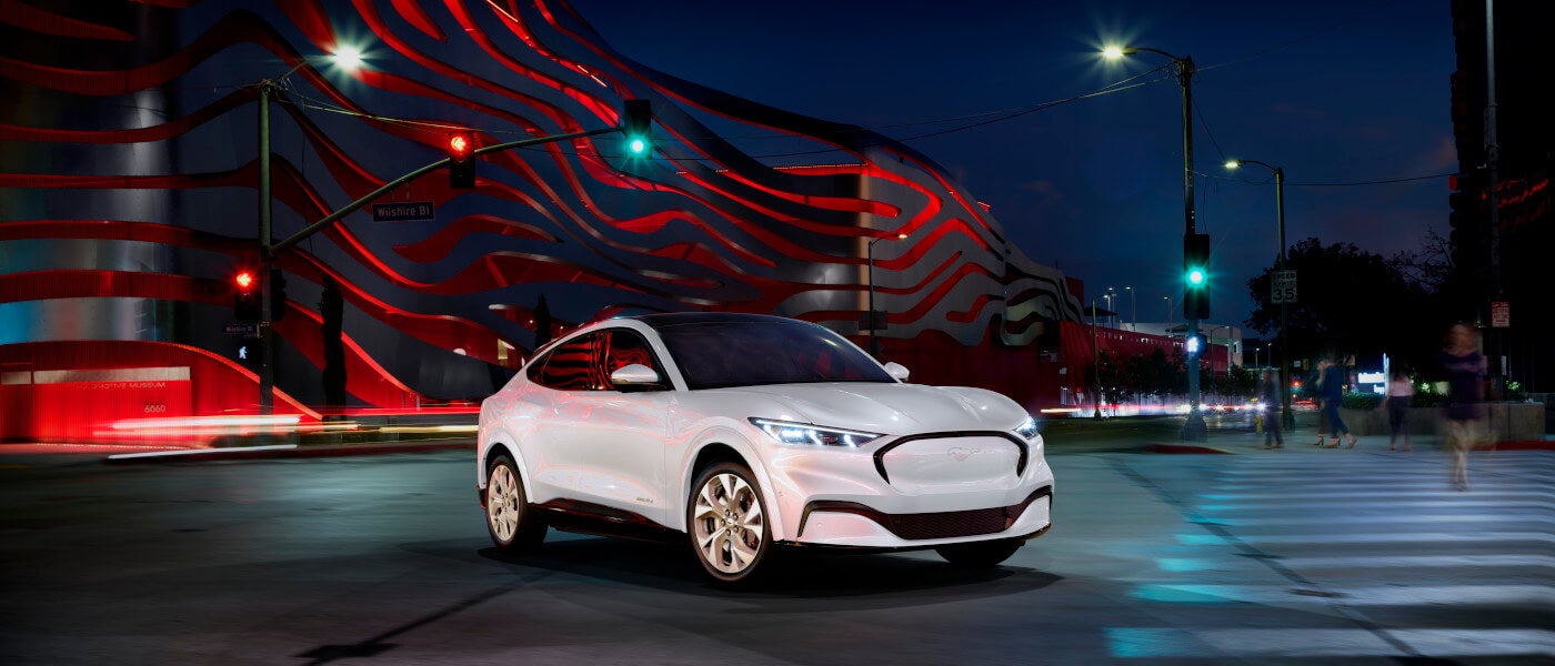 2025 Ford Mustang Mach-E Exterior White Parked In Front Of Artistic Striped Structure